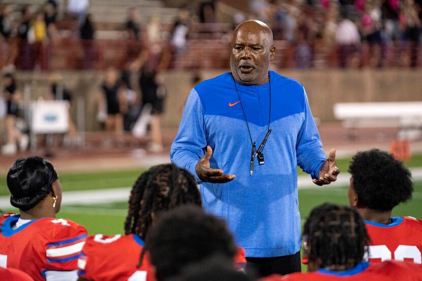 Duncanville head coach Reginald Samples talks to his team after their 38-3 victory over...