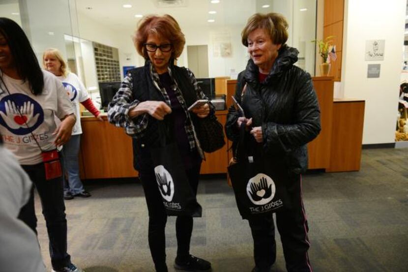 
Visitors Nancy Horowitz (left) and Rita Goldberg collect their Shabbat in a Bag at the...