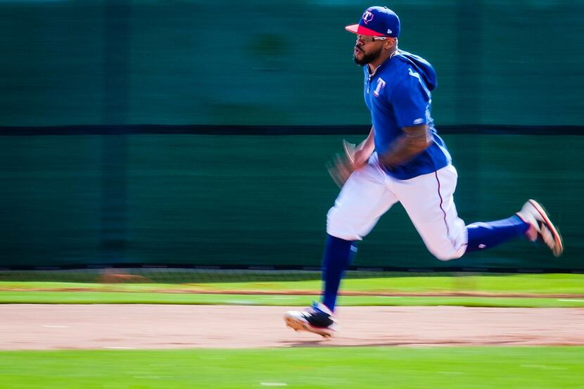 Texas Rangers outfielder Delino DeShields participates in a base running drill during the...
