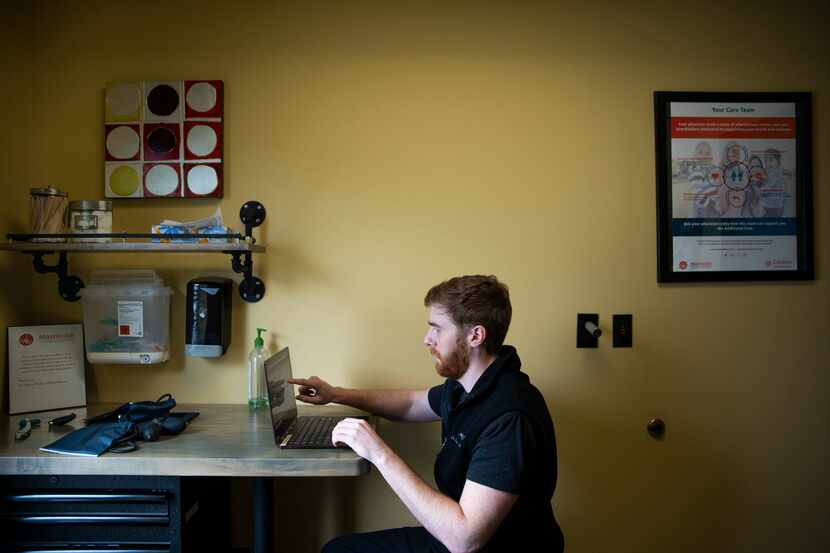 Dr. Ryan Klitgaard speaks with a patient during a telemedicine appointment online at the...