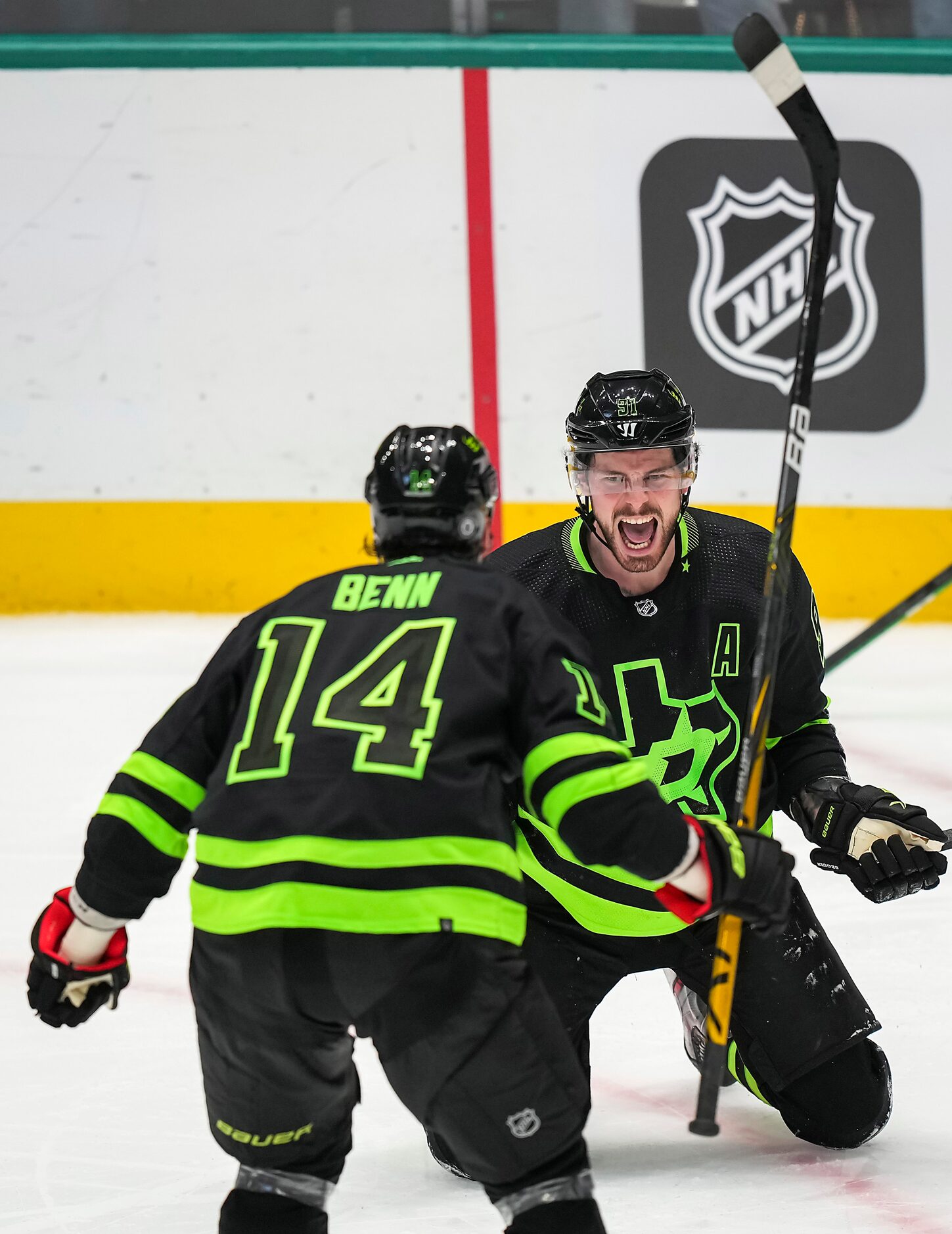 Dallas Stars center Tyler Seguin (91) celebrates with left wing Jamie Benn (14) after...