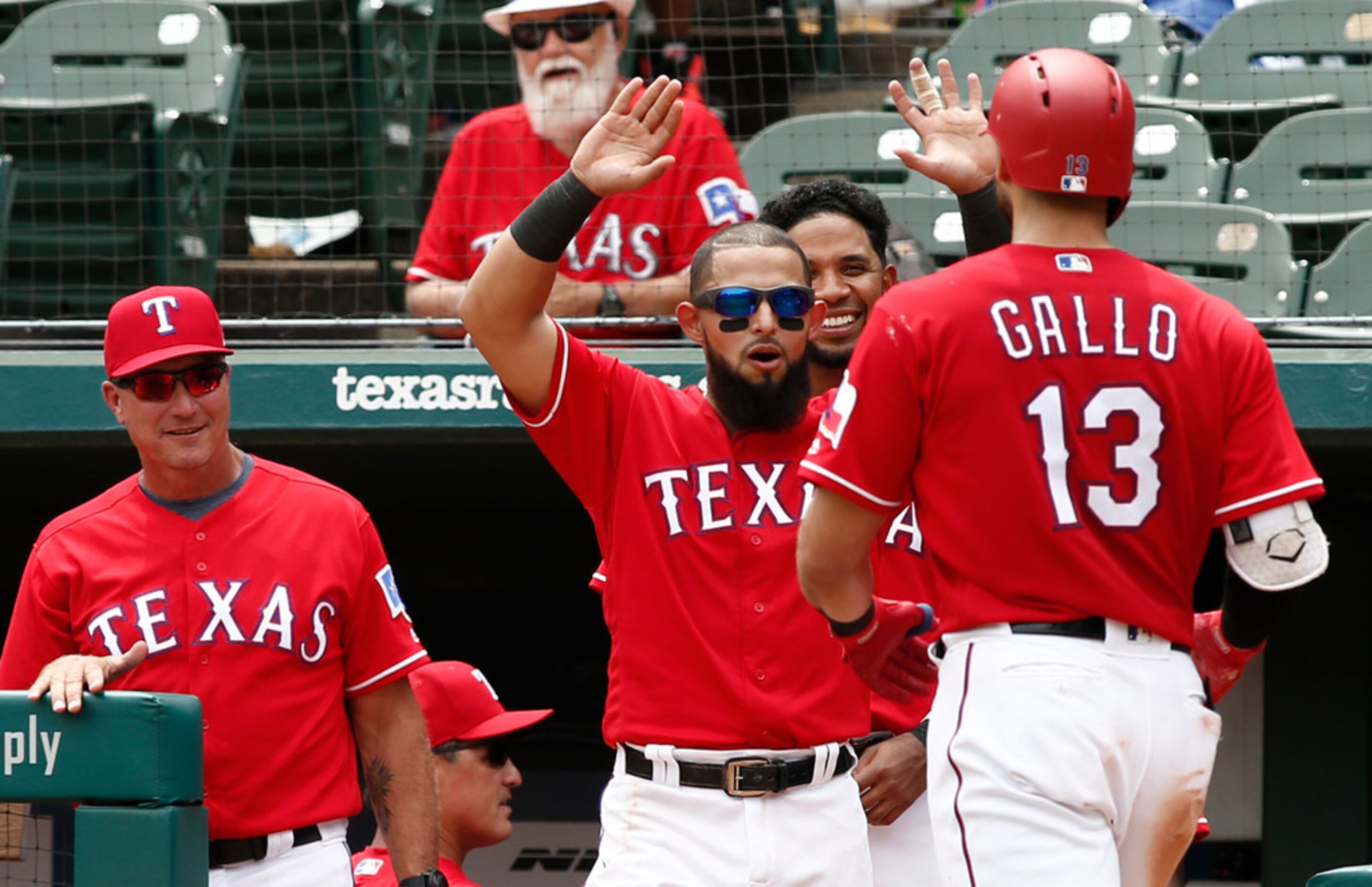 From left, Texas Rangers manager Jeff Banister, Rougned Odor and Elvis Andrus congratulate...