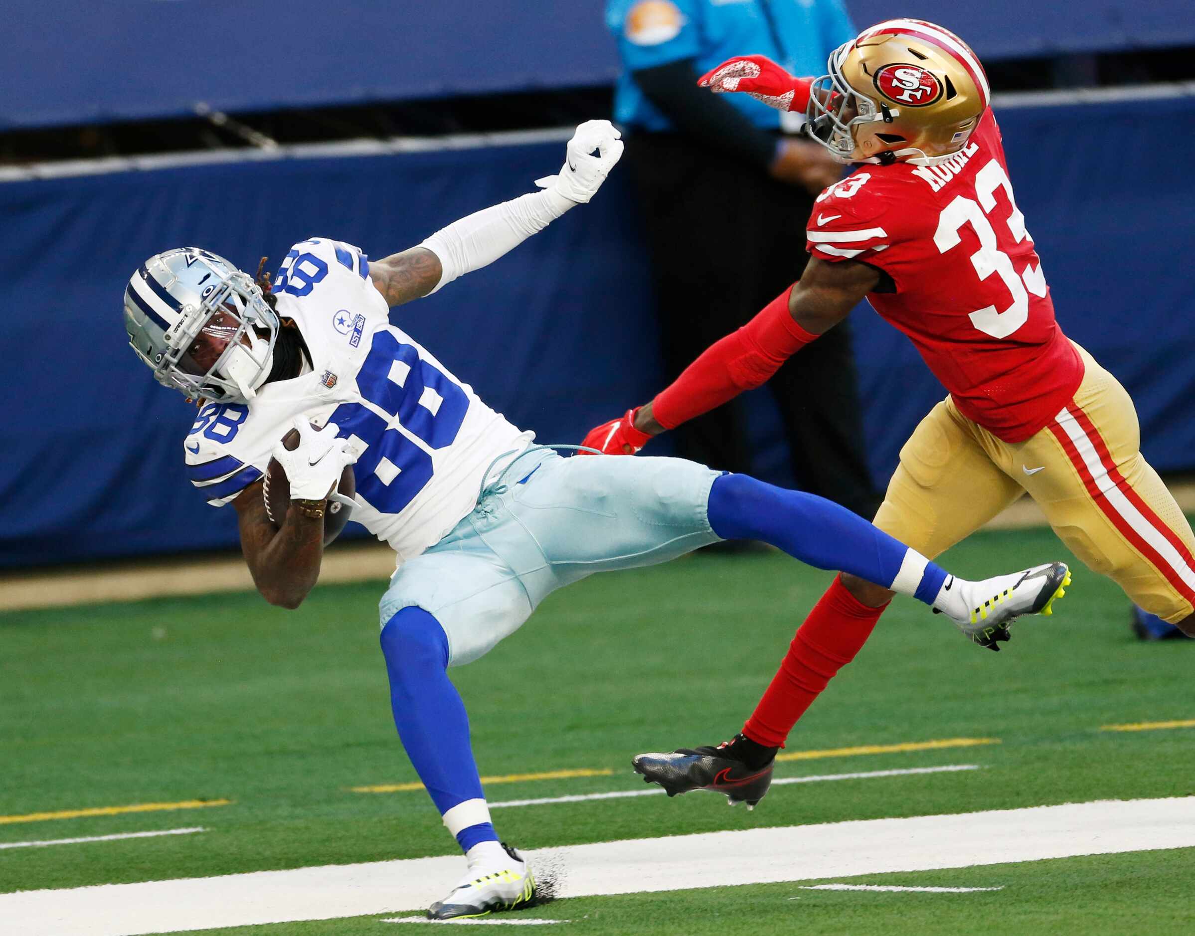 Dallas Cowboys wide receiver CeeDee Lamb (88) is pushed out of bounds by San Francisco 49ers...