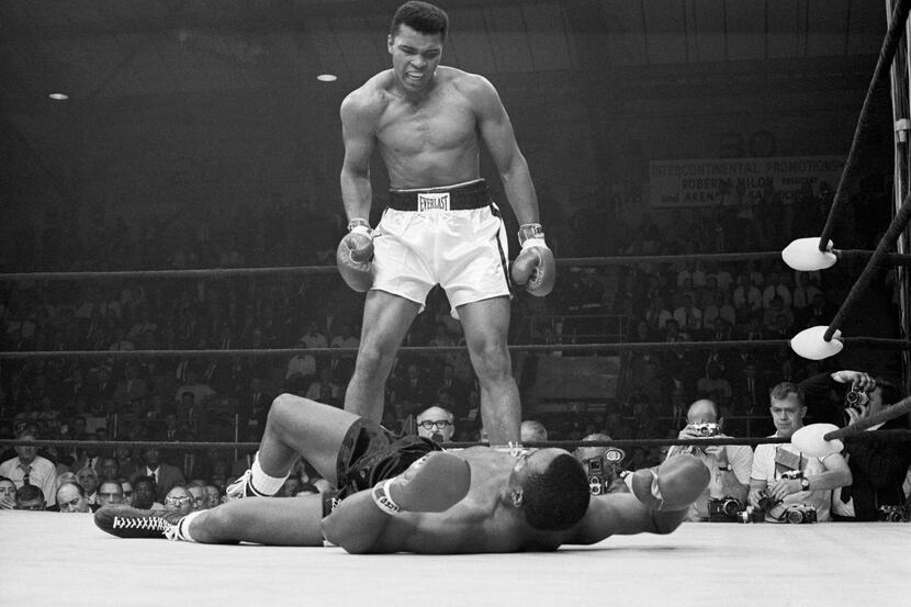 Heavyweight champion Muhammad Ali stood over Sonny Liston and taunted him to get up during...