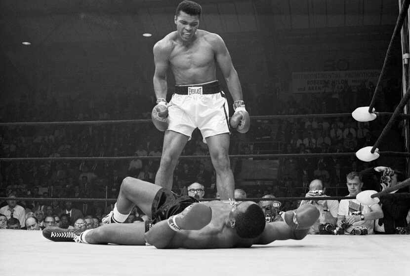 Heavyweight champion Muhammad Ali stood over Sonny Liston and taunted him to get up during...