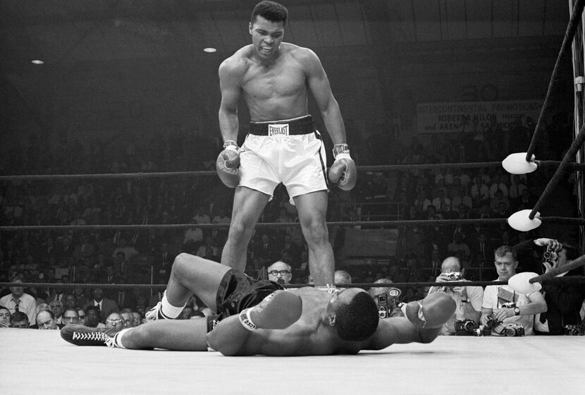 Heavyweight champion Muhammad Ali stood over Sonny Liston and taunted him to get up during...