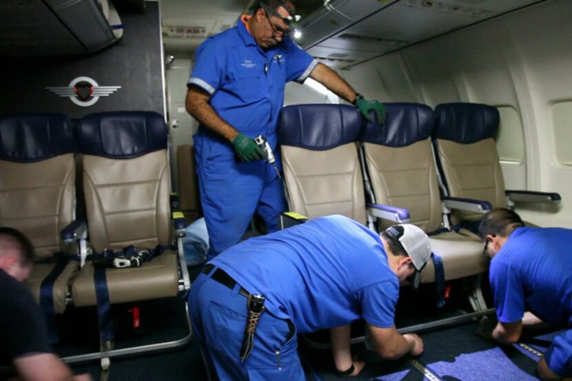 Southwest Airlines aircraft technicians installed newer, skinnier seats on a 737 at the...