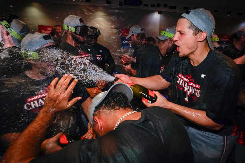 Texas Rangers shortstop Corey Seager (right) celebrates in the clubhouse after the Rangers...