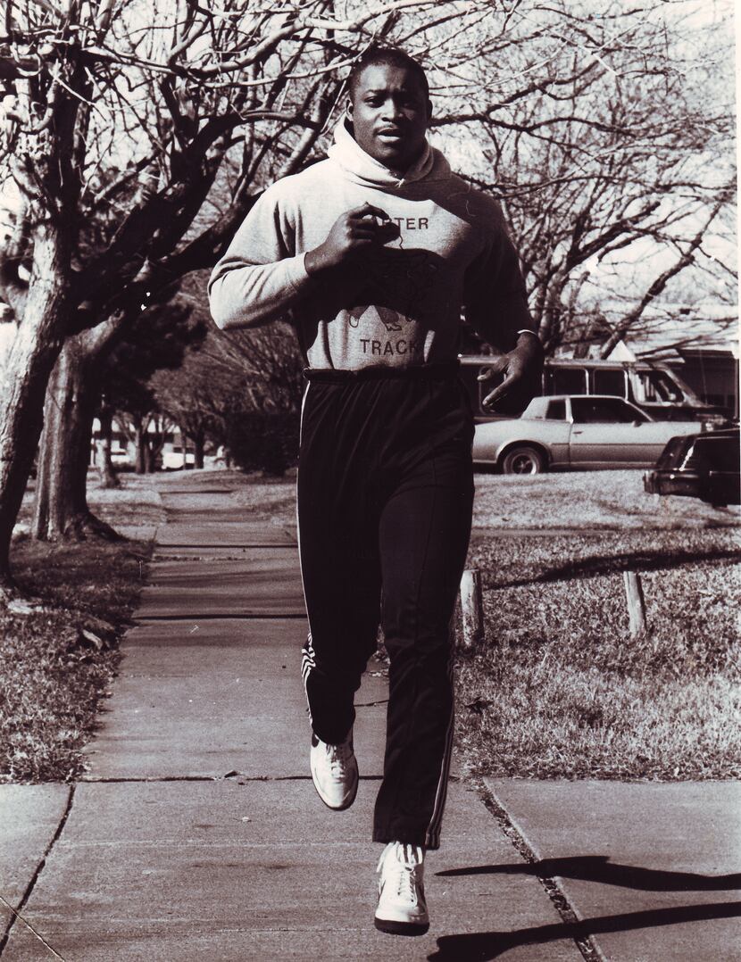 1/1/1987 --- Carter High School football player Darren Lewis jogs on his home street,...