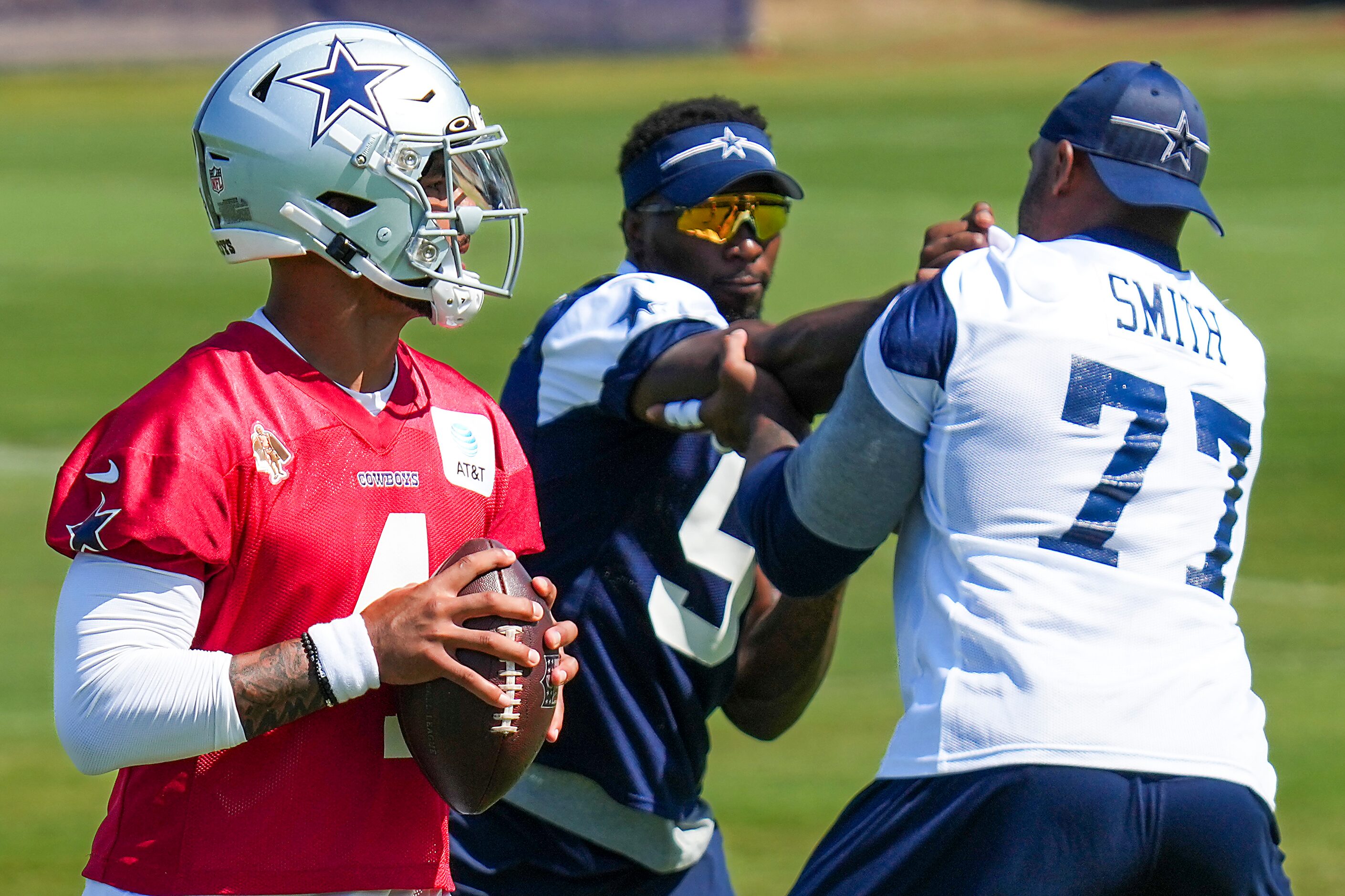 Dallas Cowboys quarterback Dak Prescott (4) looks to pass as defensive end Demarcus Lawrence...