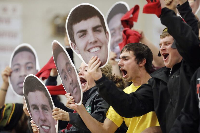 Trinity fans cheer on their team before the start of the first half of a high school...