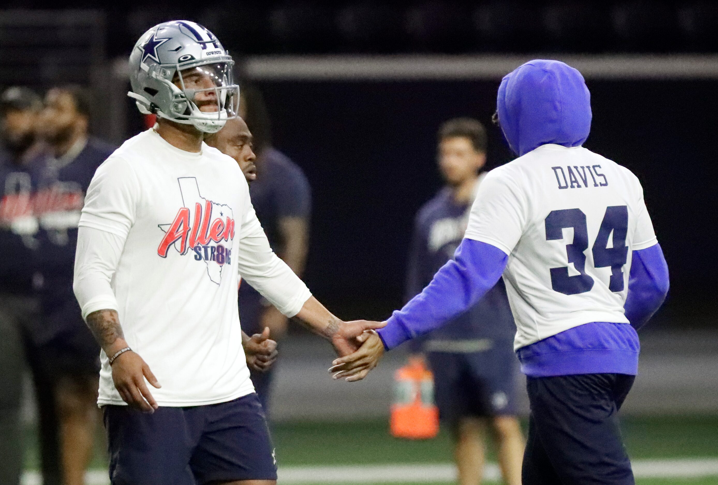 Quarterback Dak Prescott (left) is congratulated by running back Malik Davis as the Dallas...