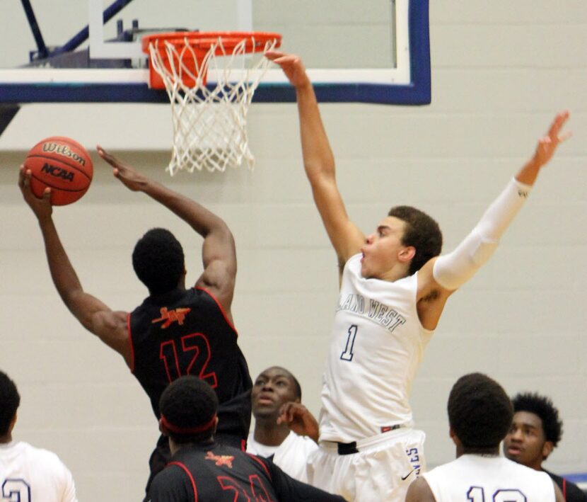 Plano West junior forward DJ Hogg (1) defends against a shot by South Grand Prairie...