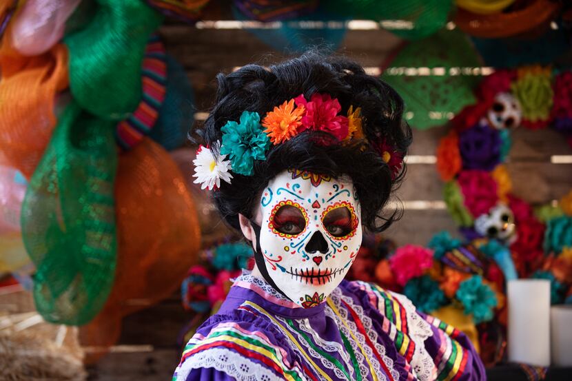 A Dia de los Muertos character named Valentina poses before meeting families at the Mystic...