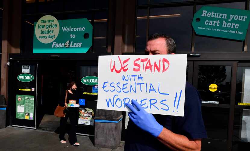 Supermarket workers held placards in protest in front of a Food 4 Less supermarket in Long...