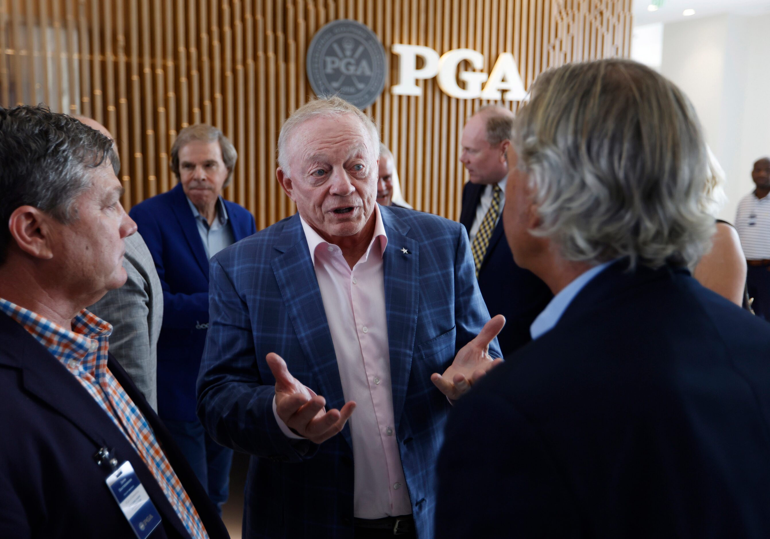 Dallas Cowboys owner and general manager Jerry Jones (center) talks to PGA’s John...