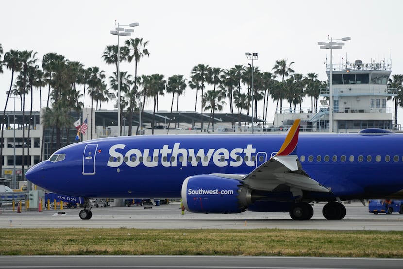 FILE - A Southwest Airlines plane taxis on the runway at the terminal the Long Beach...