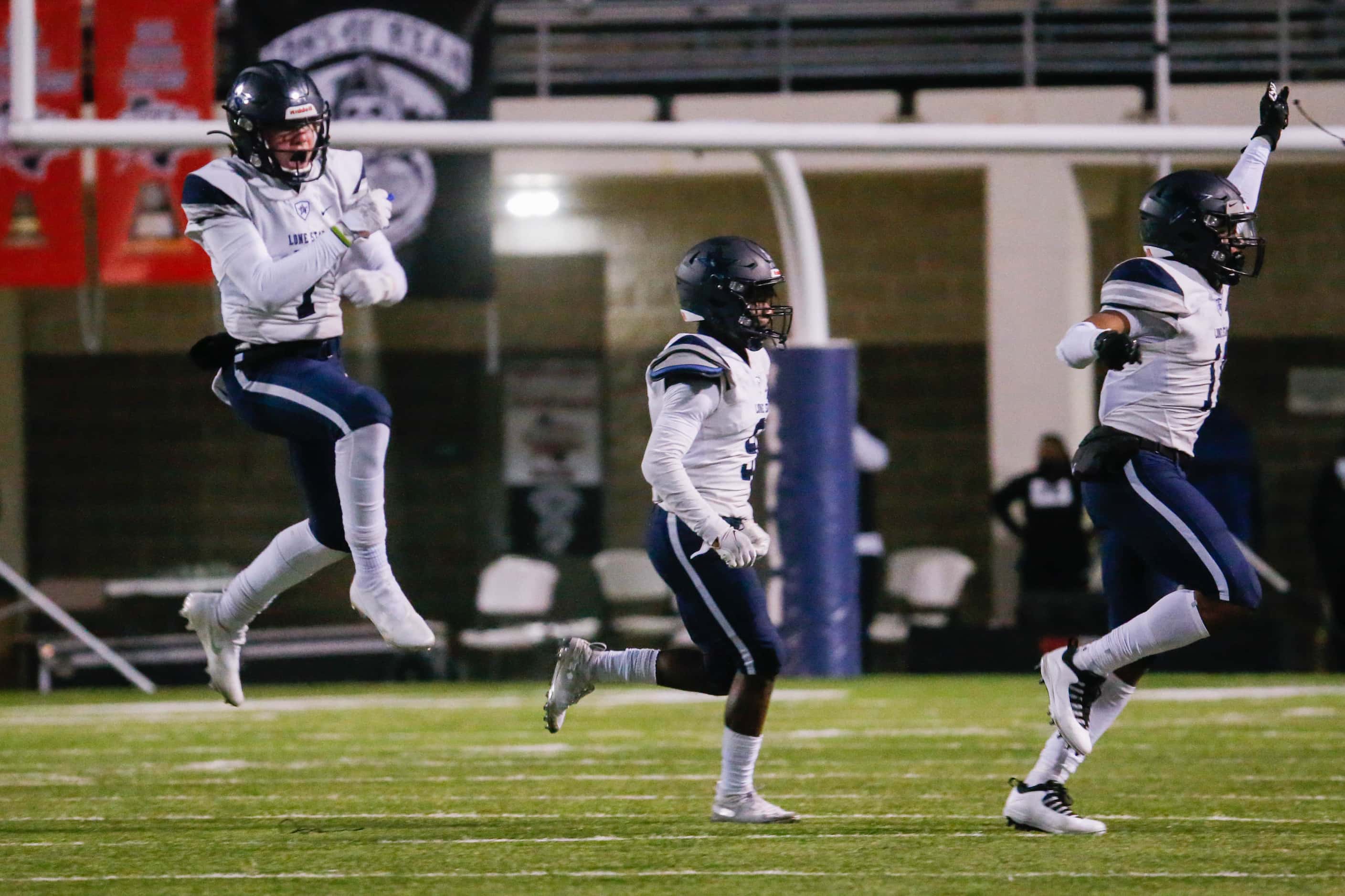 Frisco Lone Star defensive players celebrate a recovered fumble during the second quarter of...