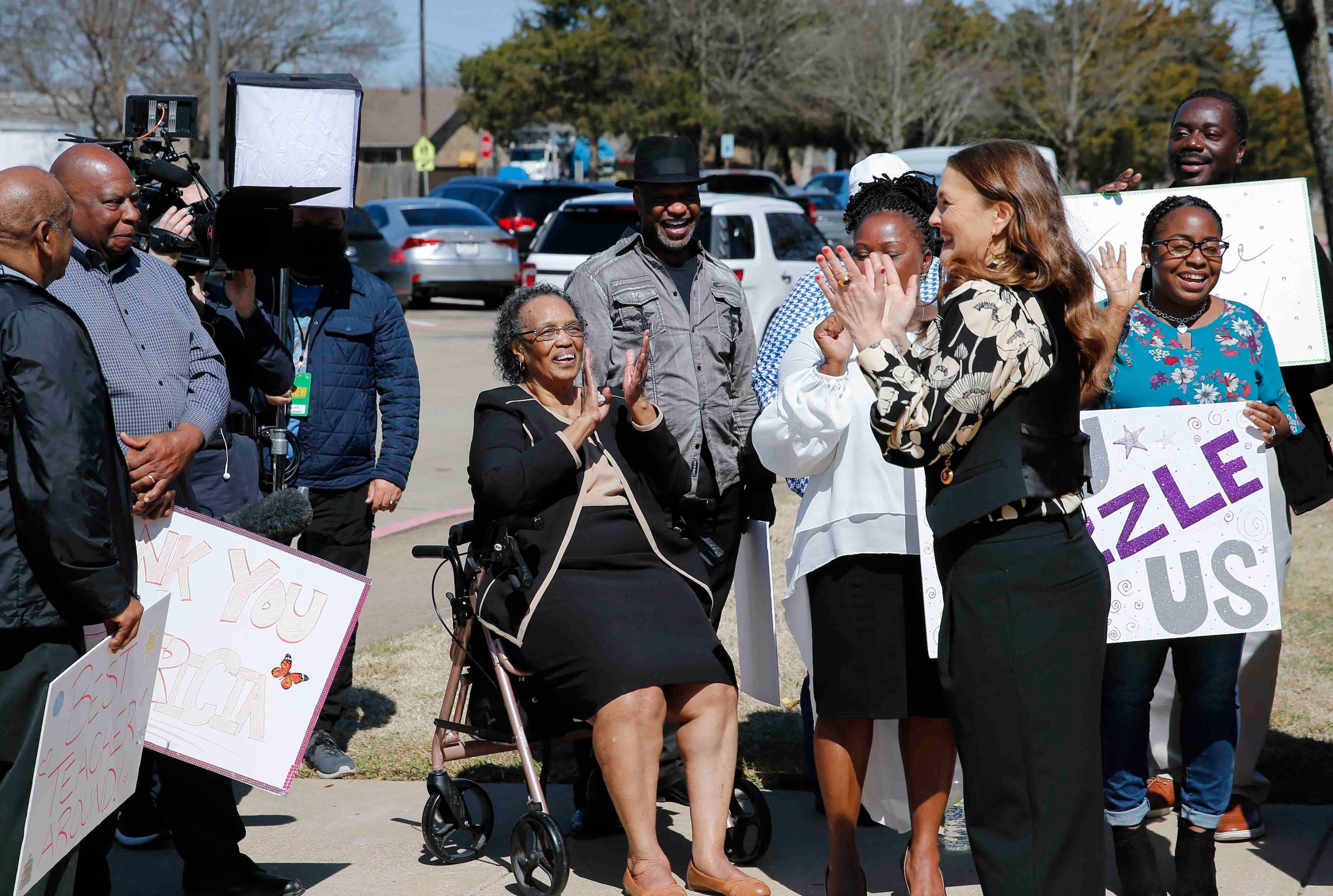 Drew Barrymore, right, cheers while talking to the family members of Patricia Byrd during...