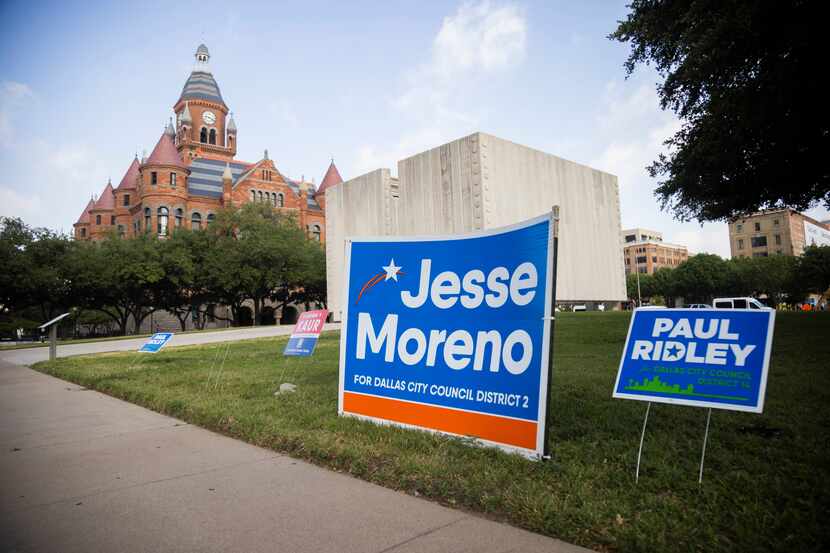 Campaign signs across the street from the George Allen Courts Building voting site a day...