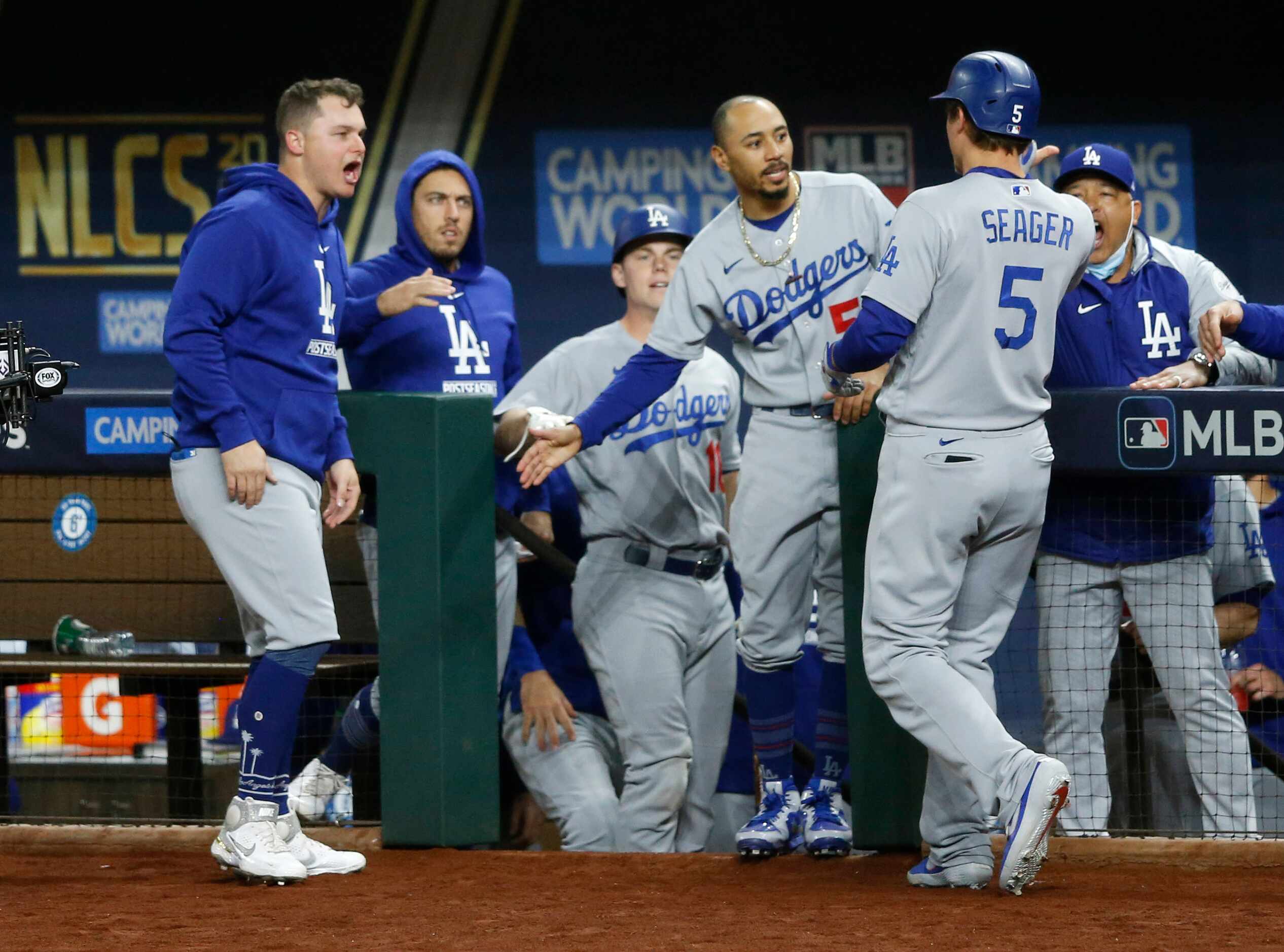 Los Angeles Dodgers shortstop Corey Seager (5) celebrates with teammates after hitting a...