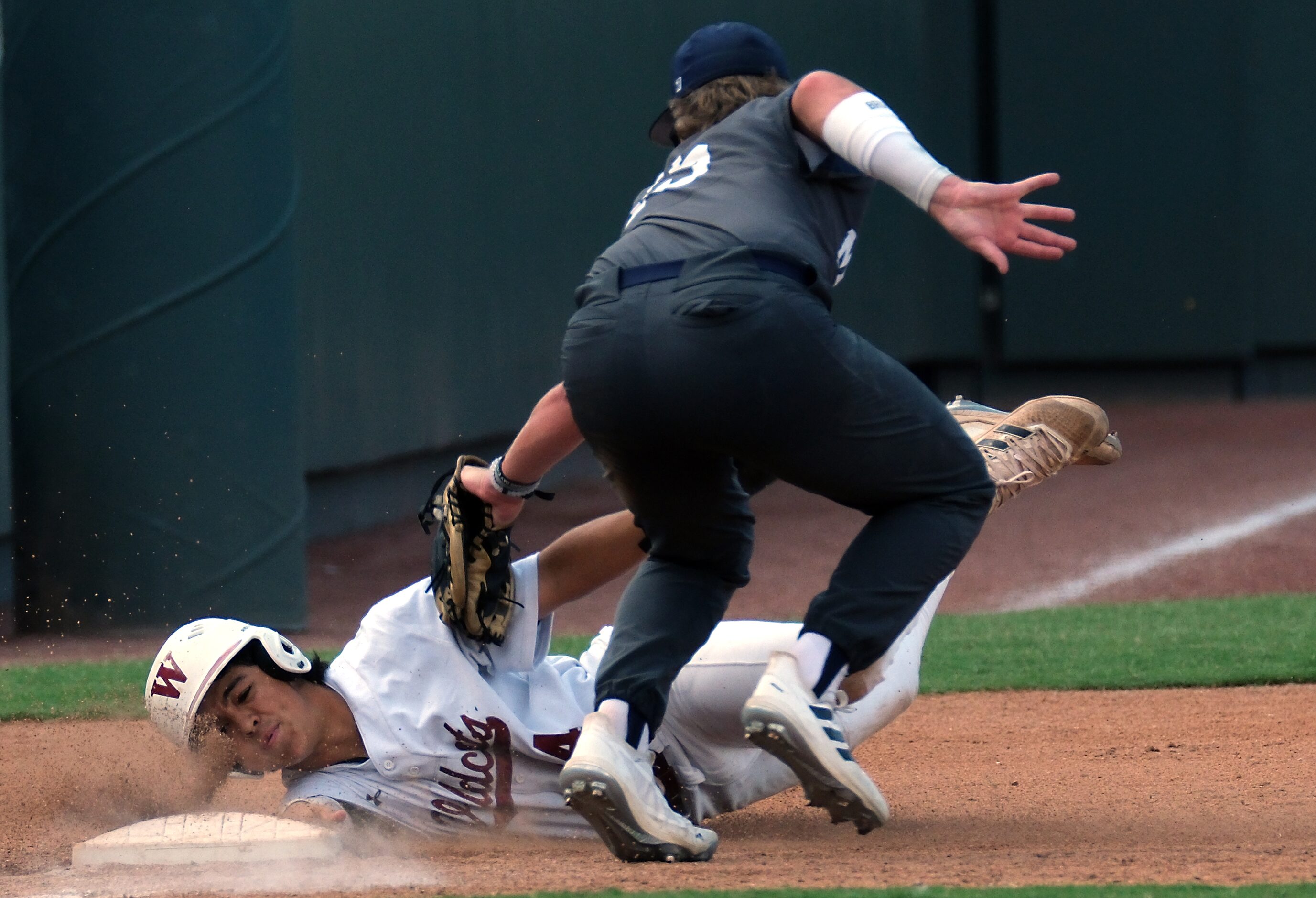 Flower Mound Josh Glaser, (15), tags out Cypress Woods Josh Vasquez, (14), at third base...