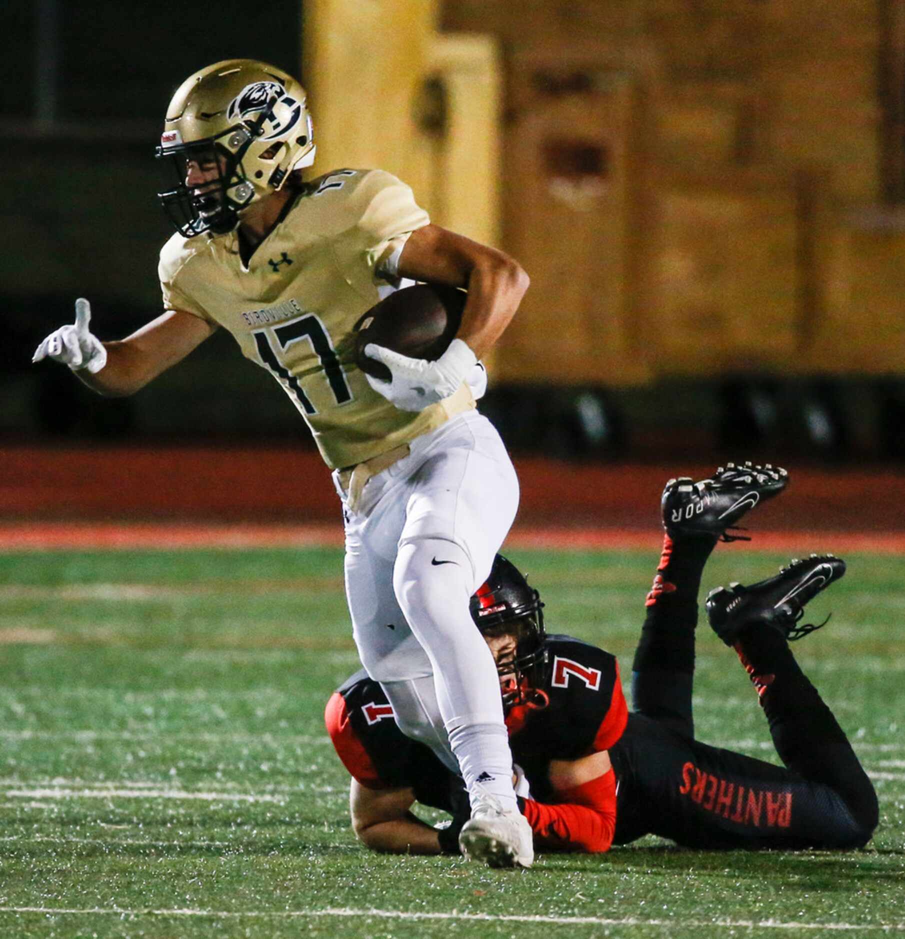 Birdville wide receiver Cooper McCasland (17) works to break free from Colleyville Heritage...