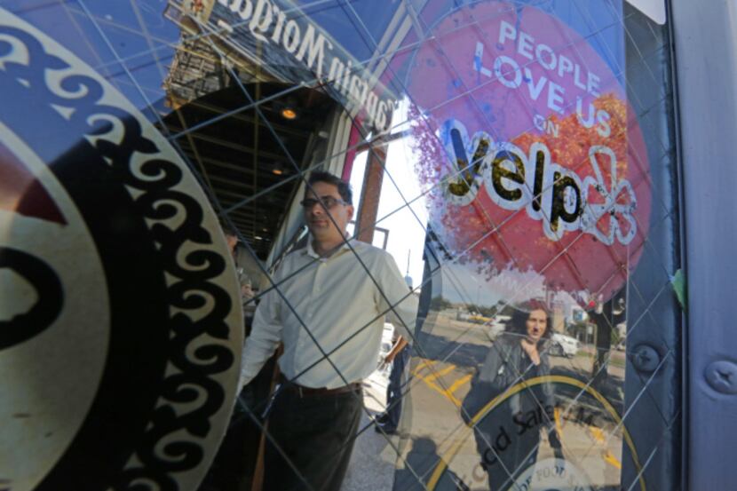 Paul Hanlon and Stephenie Bowen walk into Velvet Taco, which proudly displays a Yelp...