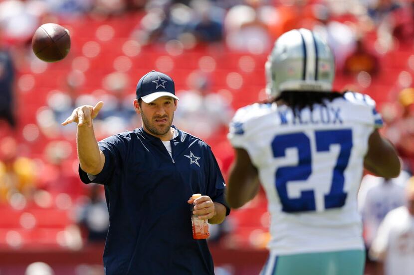 Dallas Cowboys quarterback Tony Romo (9) throws the ball to Dallas Cowboys free safety J.J....