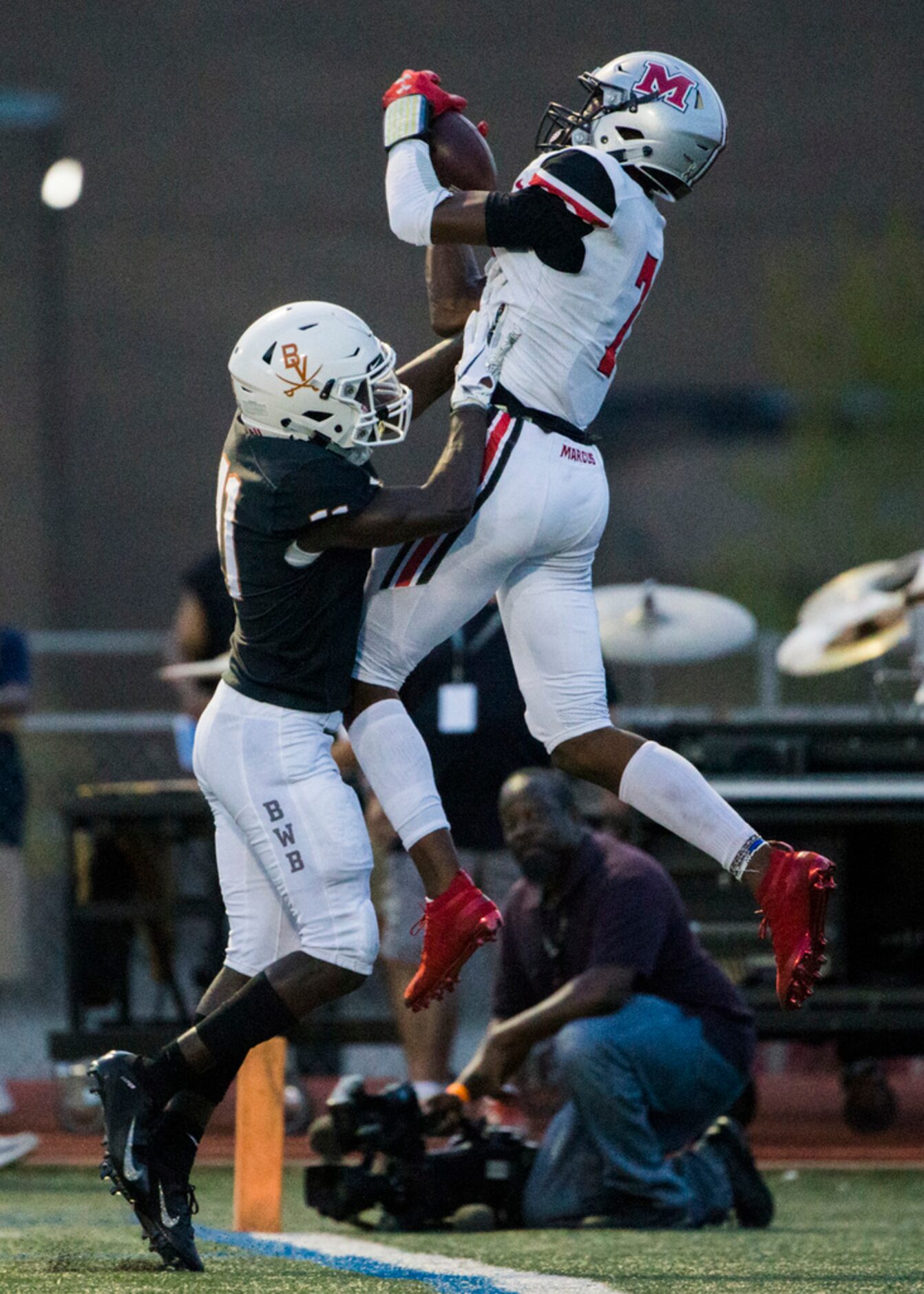 Arlington Bowie defensive back Jalen Curvin (11) pushes Flower Mound Marcus wide receiver J....