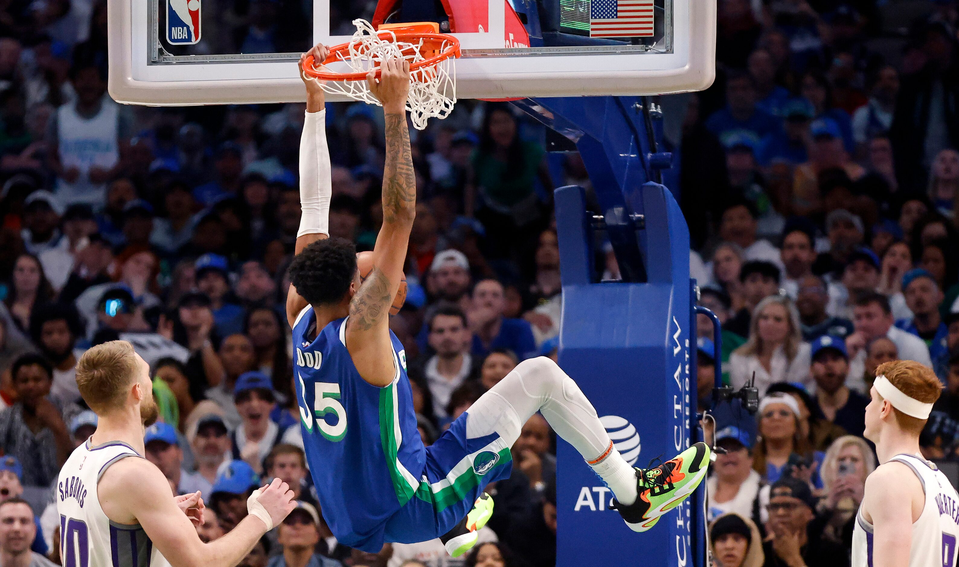 Dallas Mavericks forward Christian Wood (35) hangs on the rim after a second half dunk...