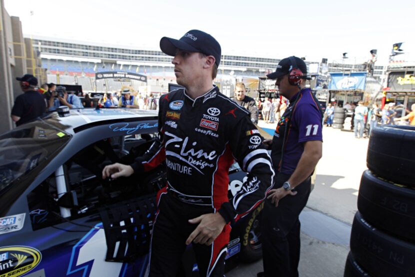 Sprint Cup Series driver Denny Hamlin (11) climbs out of his car during a practice session...