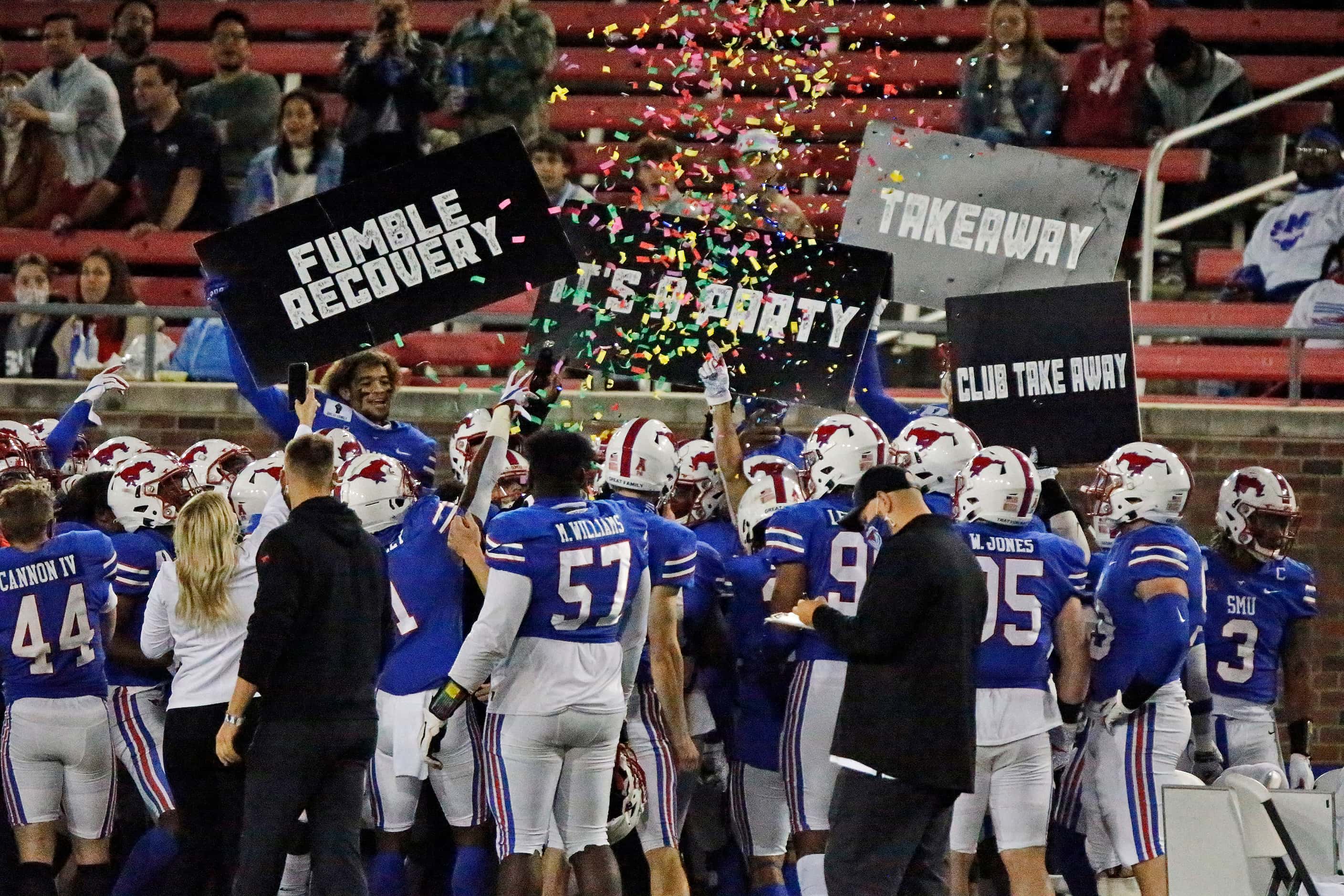 The SMU defensce celebrates on the sideline after a fumble recovery during the first half as...