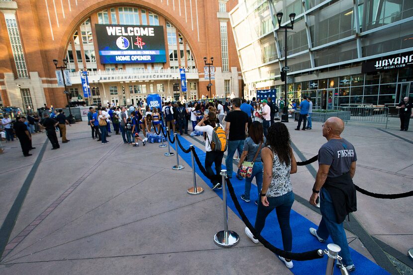 Fans walk the "Blue Carpet" on their way to the arena before the Dallas Mavericks home...