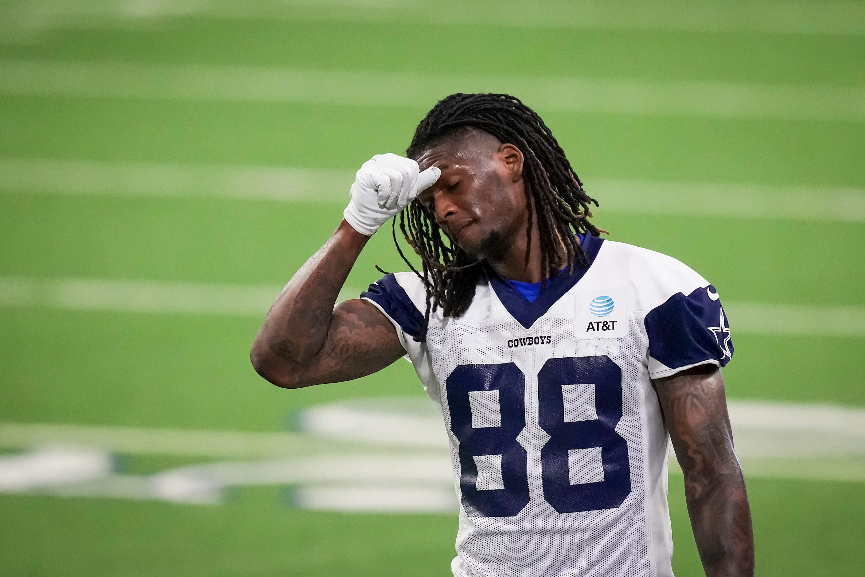 Dallas Cowboys wide receiver CeeDee Lamb wipes his brow during the OTA team's practice at...