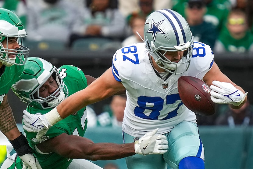 Dallas Cowboys tight end Jake Ferguson (87) fumbles as he is hit by Philadelphia Eagles...