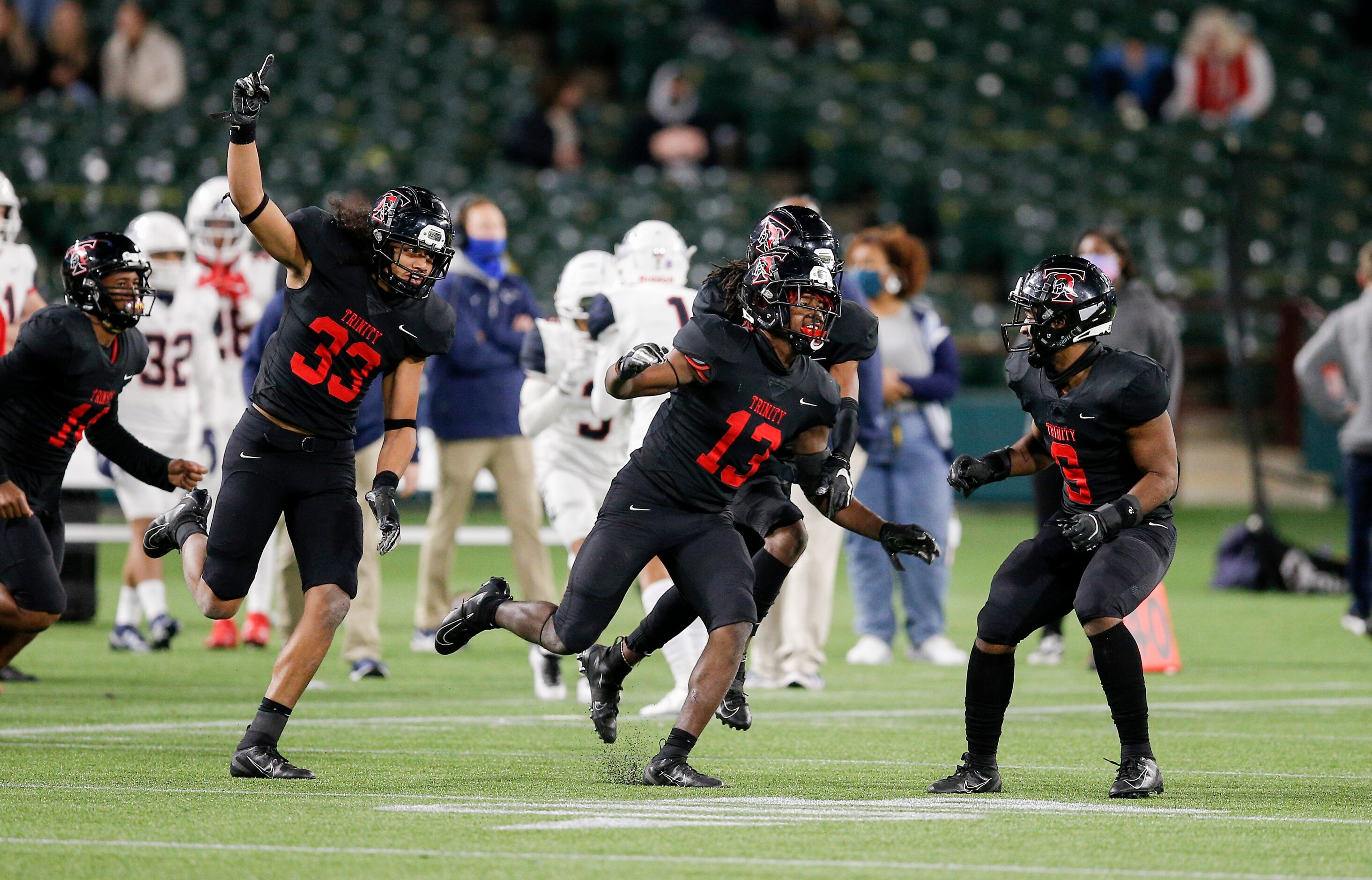 Euless Trinity junior defensive back Jacob Schaeffer (13) celebrates intercepting a pass...