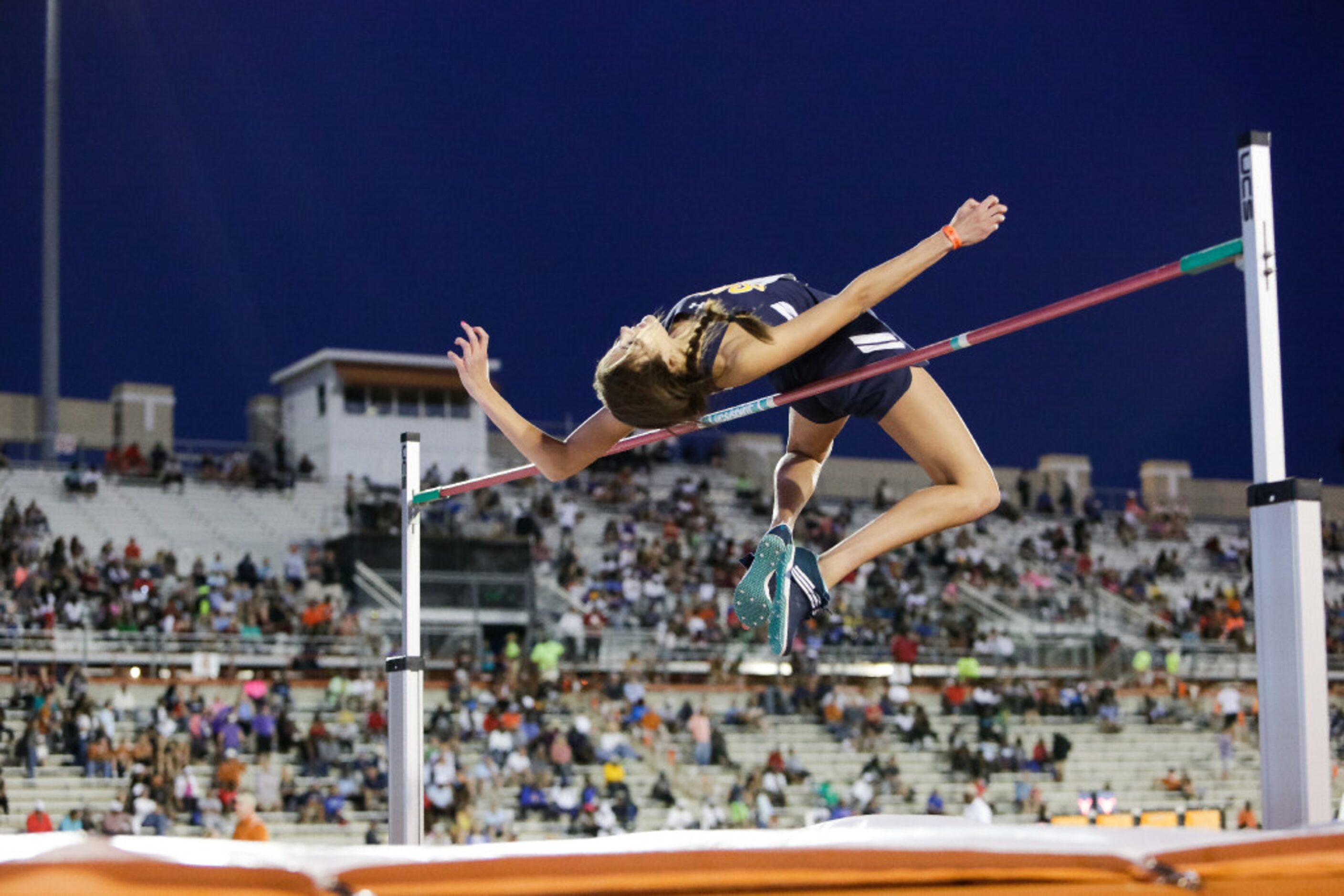 Highland Park senior Falyn Reaugh smiles after clearing the bar at a height of 6'0" during...