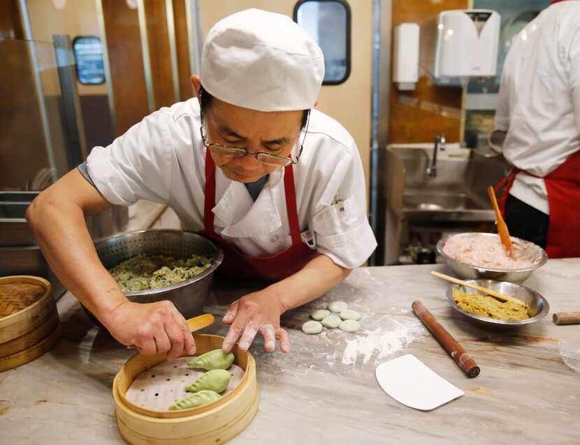 Cheng-Hui “Tony” Lai prepares vegetable dumplings in a glassed-in station in the dining room.