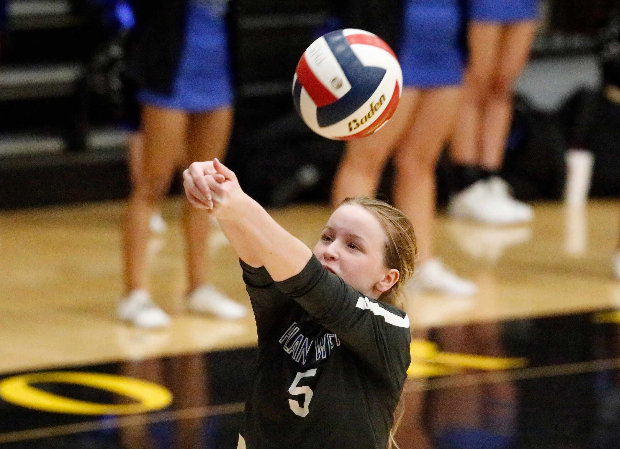 Plano West High School libero Ella Willenborg (5) keeps the play alive during game two as...