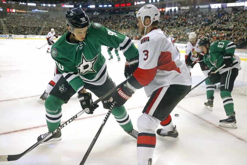 Dallas Stars' Jason Spezza (90) battles Ottawa's Marc Methot (3) for the puck in the first...