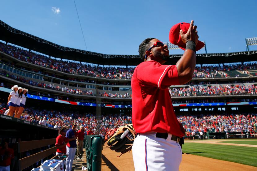 Texas Rangers shortstop Elvis Andrus (1) makes the sign of the cross at the end of 'God...