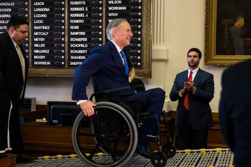 Texas Gov. Greg Abbott makes his way to the podium in the Texas House of Representatives...