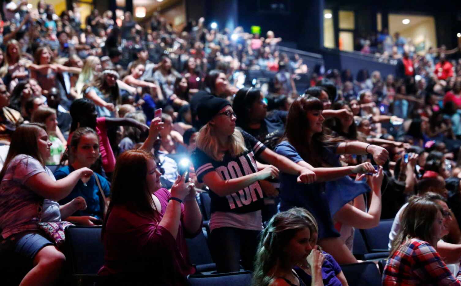The crowd dances to hip-hop while waiting for Fifth Harmony to perform at Verizon Theatre in...