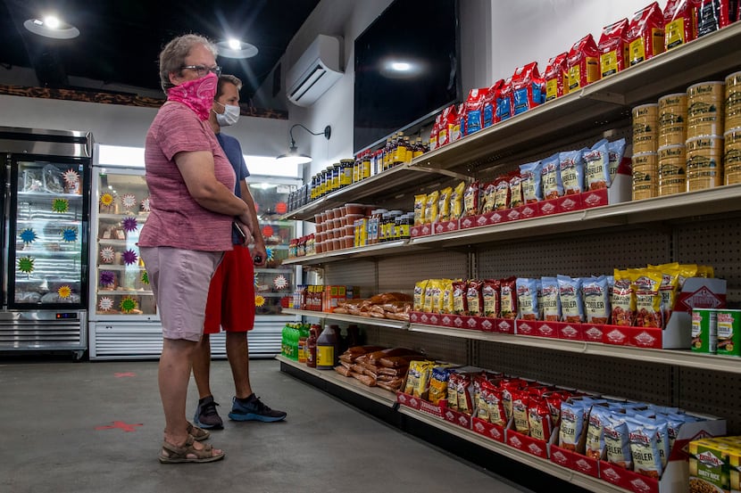 Cindy Brachey and her son, Tommy, peruse the market cajun convenience items kept in stock at...