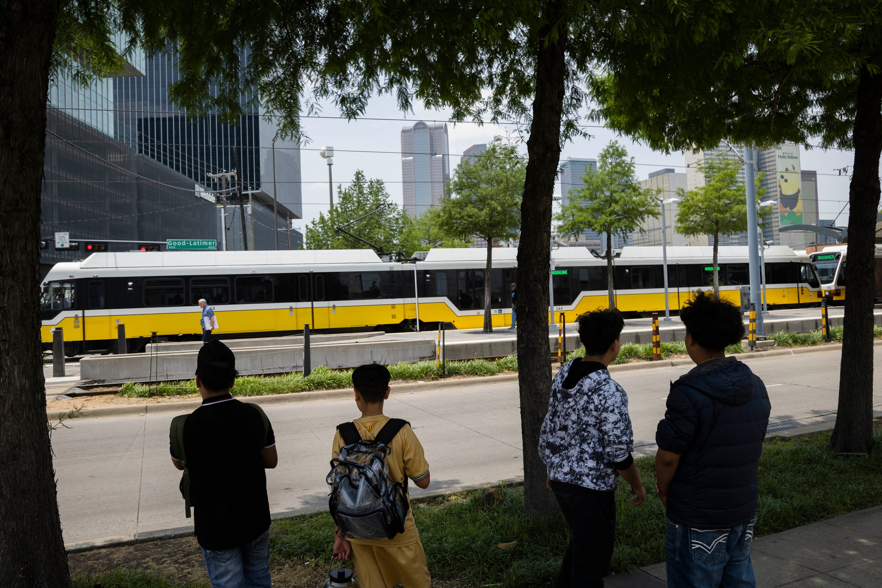 Students from Uplift Luna Preparatory School wait across the street from the DART Deep Ellum...