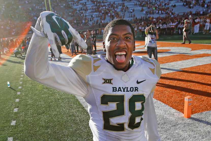 Baylor safety Orion Stewart (28) gives the "Horns down" sign after the Bears' 28-7 win...