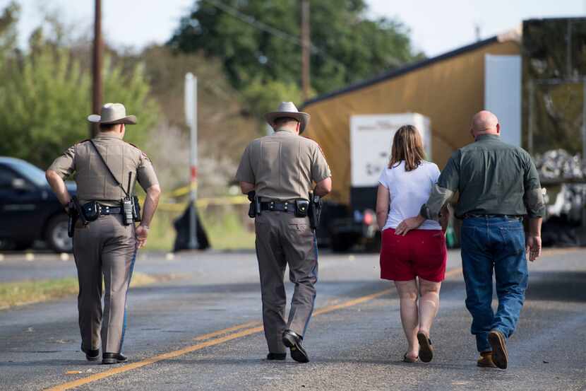 Texas state troopers walk with Sutherland Springs First Baptist Church Pastor Frank Pomeroy...