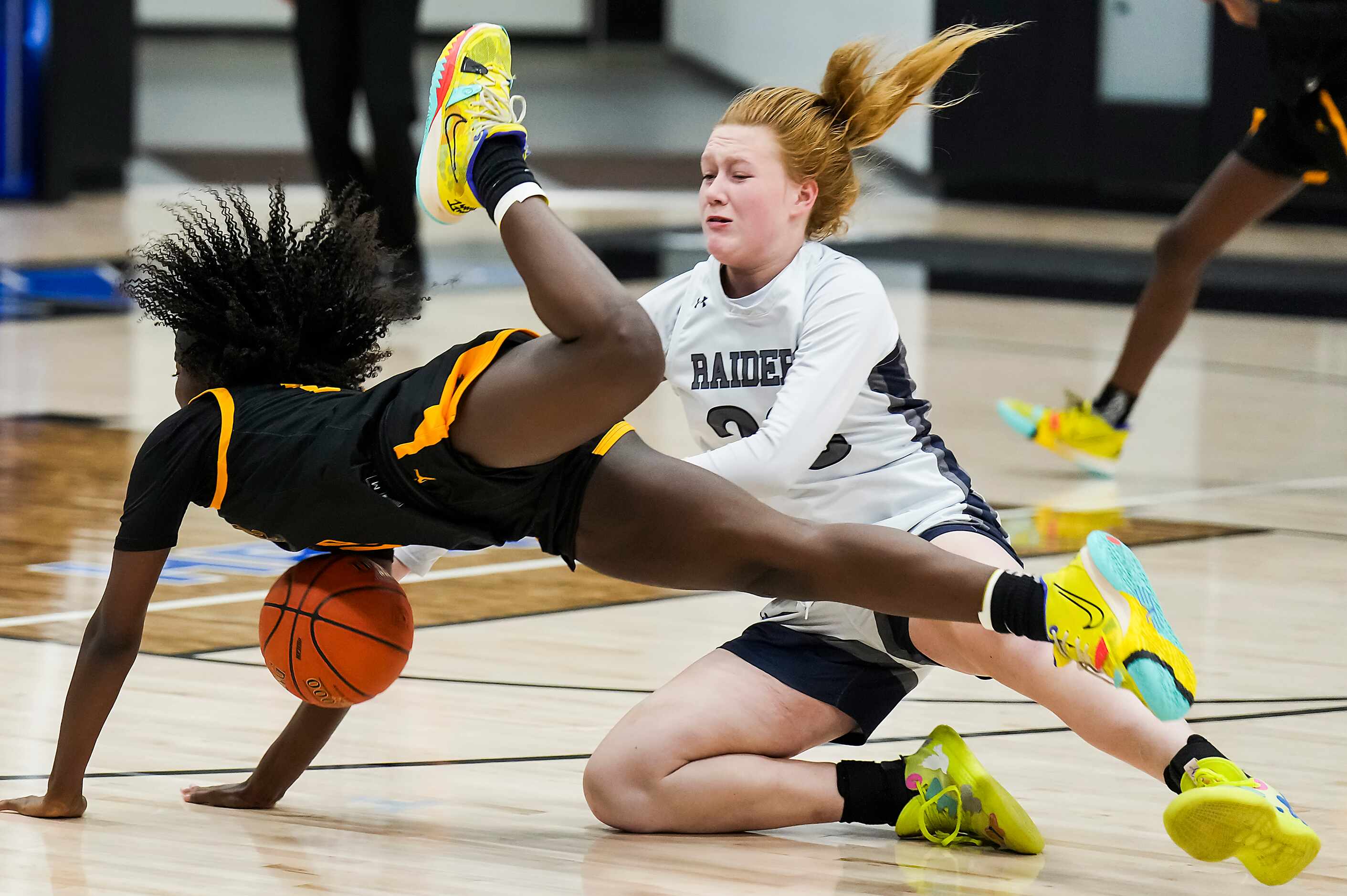 Frisco Memorial's Jasmyn Lott (10) is fouled by Wylie East's Kerbie Cash (23) during the...