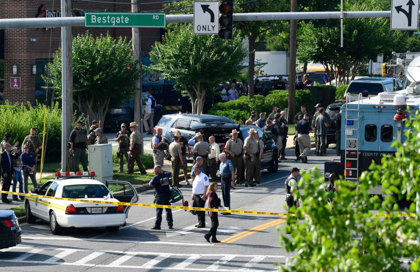 Police secure the scene of a shooting at an office building housing the Capital Gazette...